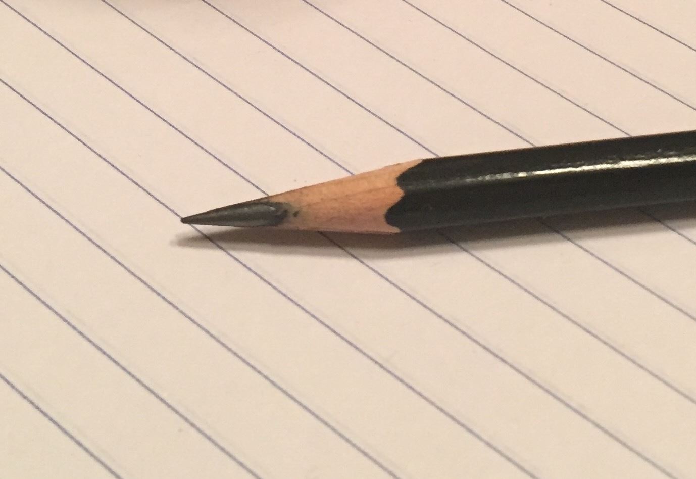 Sharpened pencil on notepad.