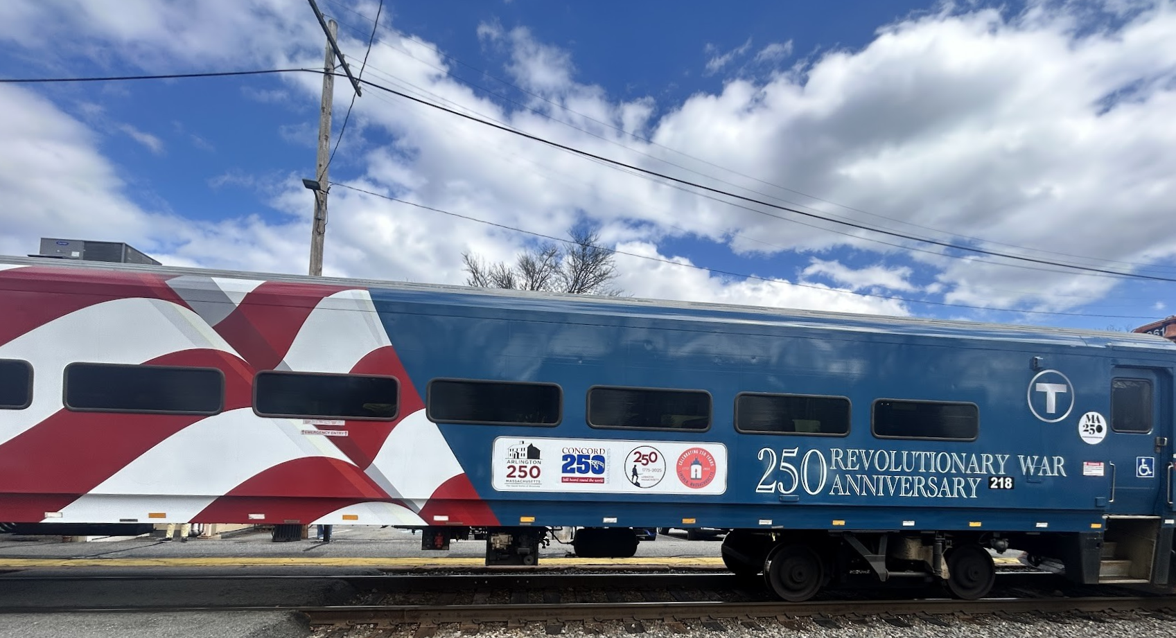 MBTA Train wrapped in the red, white, and blue flag with 250 logo