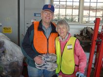 Couple Holding a Pair of Running Shoes
