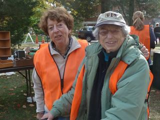 2 Women Posing for a Picture in Orange Jackets